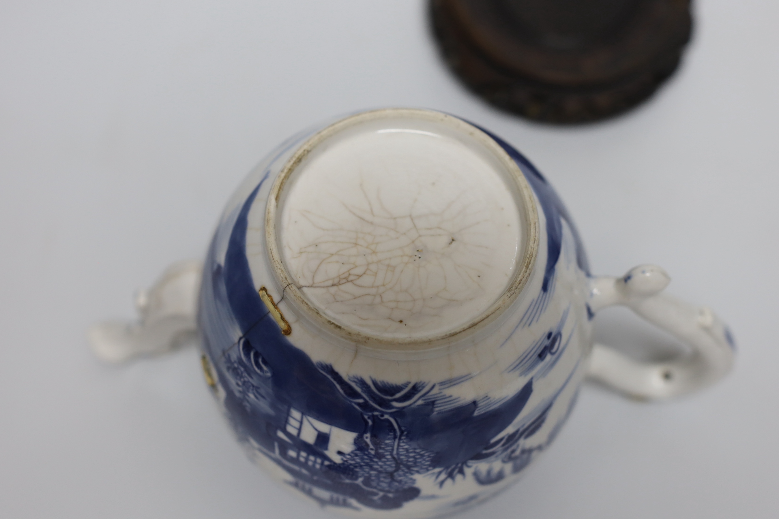 An 18th century Chinese blue and white teapot and cover, with hardwood stand, 19cm total height